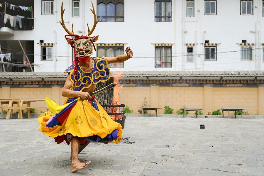 Deer Dancer at the Fire — Cham Festival, Bhutan — Fine art canvas print by Naomi McLeod