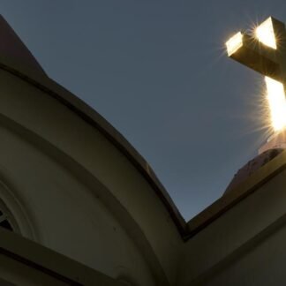 Divine Light — Sunburst Through Church Cross at Golden Hour