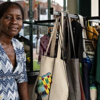 African Artisan with Handcrafted Bags at Local Market