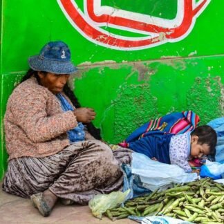 Andean Market Vendor with Grandchild Selling Fava Beans