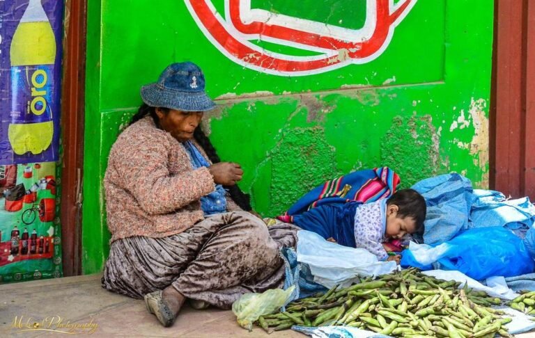 Andean Market Vendor with Grandchild Selling Fava Beans
