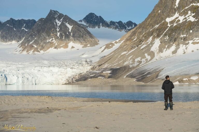 Arctic Explorer Contemplating Glacier in Svalbard Mountains