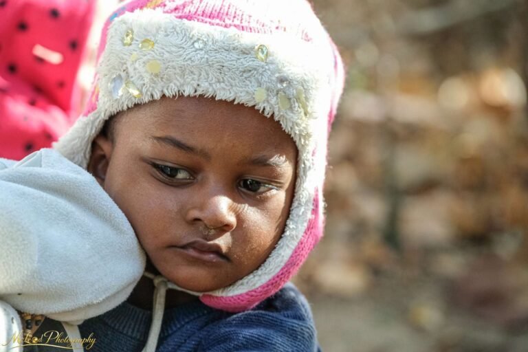 Contemplative Child in Pink Winter Hat – Fine Art Portrait