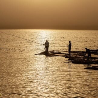 Golden Hour Fishermen Silhouettes on Mediterranean Rocks
