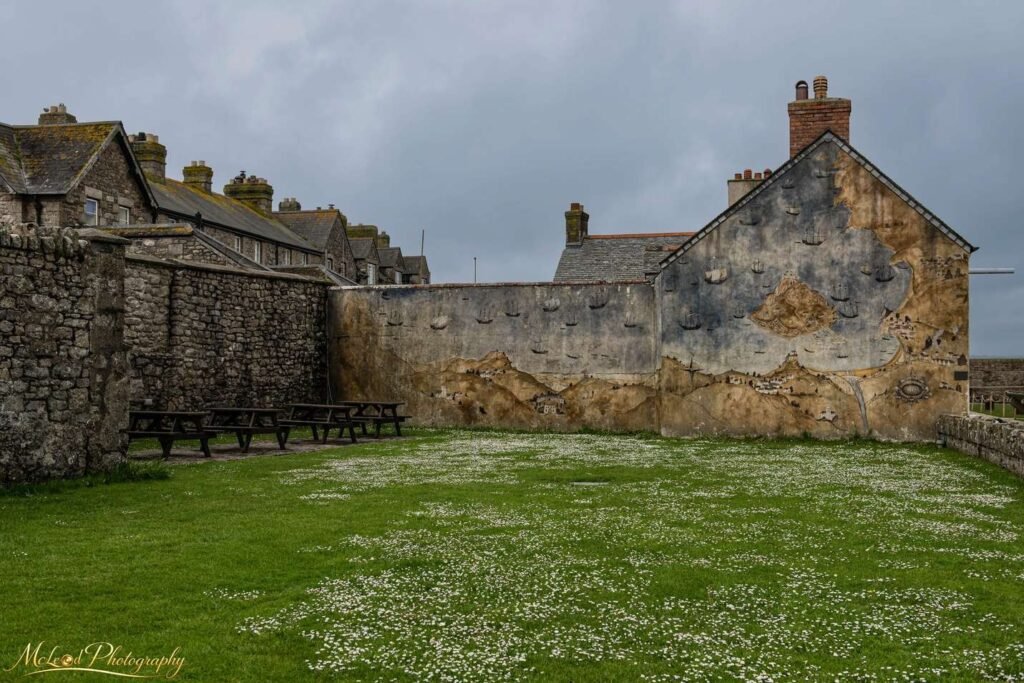 Historic Maritime Mural on Portland Stone Village Wall — Fine art canvas print by Naomi McLeod