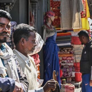 Indian Street Market Vendors Among Colorful Textiles