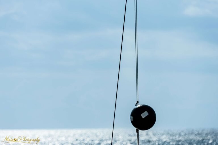 Minimalist Sailboat Rigging Against Ocean Horizon