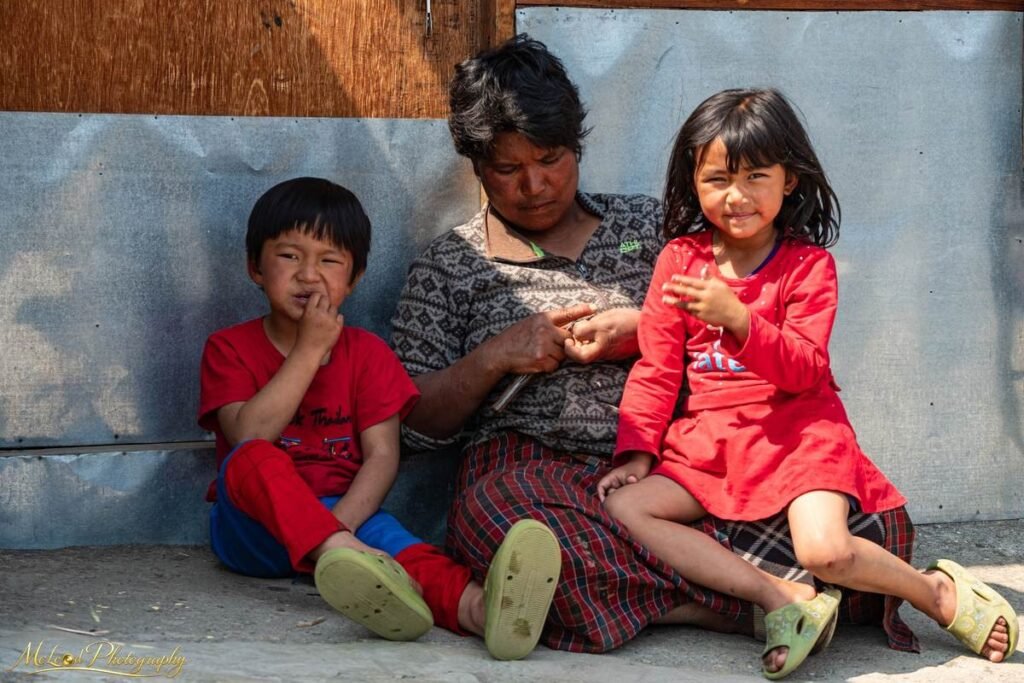 Nepali Grandmother Caring for Grandchildren Village Portrait — Fine art canvas print by Naomi McLeod