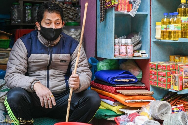 Nepali Shopkeeper in Colorful Market Stall Kathmandu
