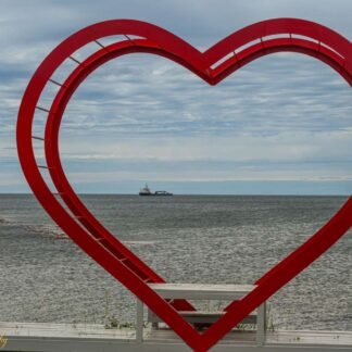 Red Heart Sculpture Framing Ocean Ship - Romantic Coastal Art
