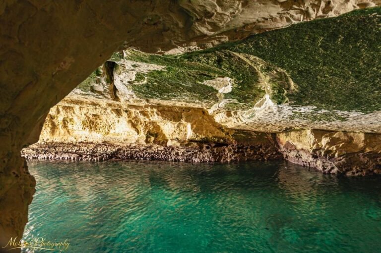 Turquoise Waters Inside Golden Limestone Sea Cave
