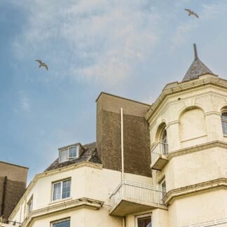 Victorian Seaside Hotel with Turret and Soaring Seagulls