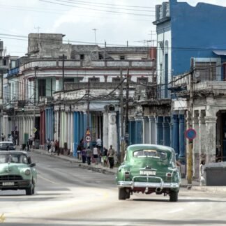 Classic Green Cars on Havana Street with Colonial Buildings