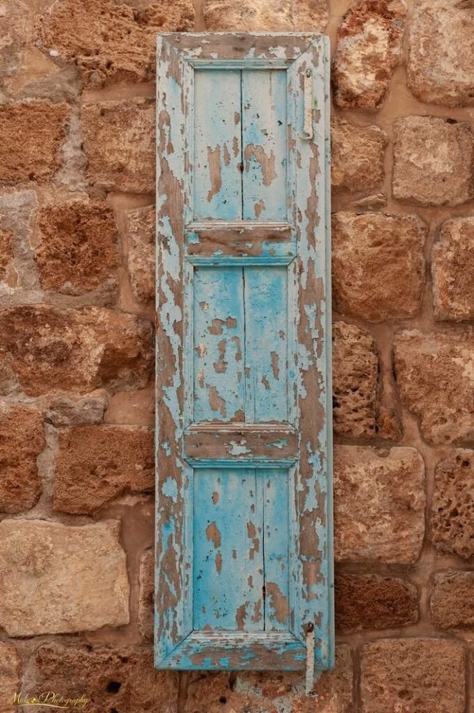 Rustic Turquoise Shutter on Ancient Stone Wall Art Print — Fine art canvas print by Naomi McLeod