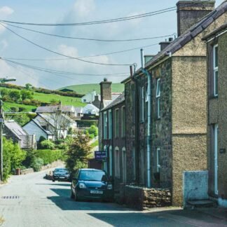 Charming Welsh Village Street with Stone Cottages and Green Hills