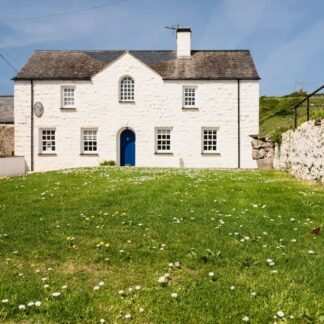 Charming Welsh Cottage with Blue Door and Daisy Lawn